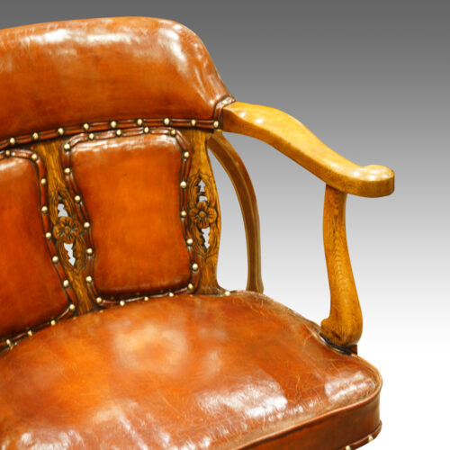 Edwardian oak and leather desk chair arm