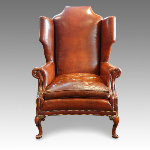 Queen Anne style walnut and leather wing chair front