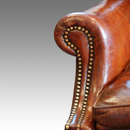 Queen Anne style walnut and leather wing chair arm