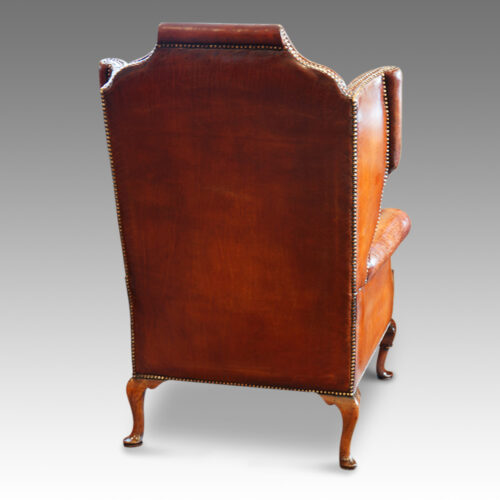 Queen Anne style walnut and leather wing chair rear view
