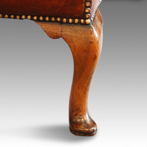 Queen Anne style walnut and leather wing chair rear leg