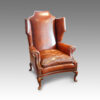 Queen Anne style walnut and leather wing chair