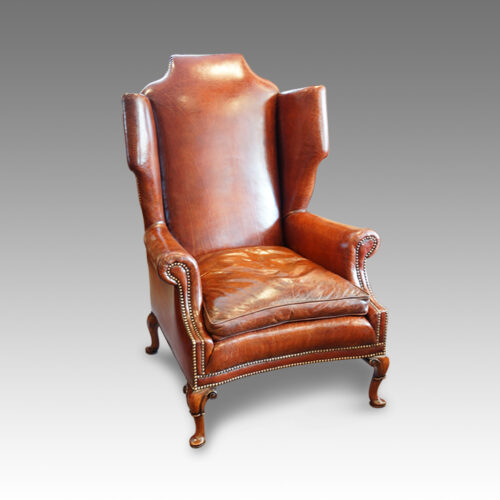 Queen Anne style walnut and leather wing chair
