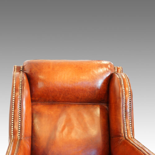 Pair of Edwardian leather club chairs head rest