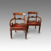 Pair of William IV mahogany scroll arm armchairs