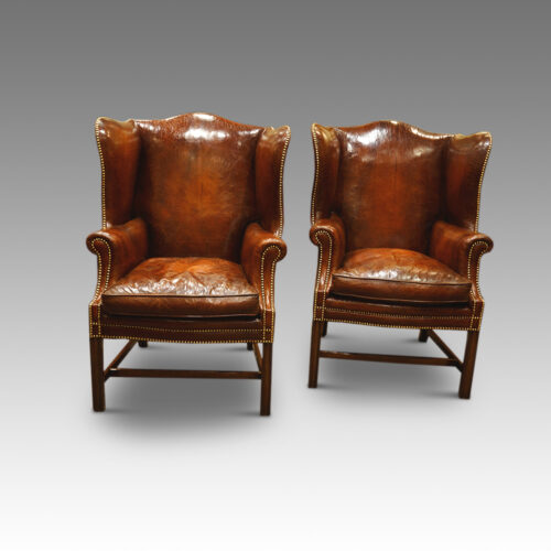 Antique pair of leather wing-chairs