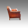 Pair of Edwardian club chairs with claw and ball feet side view