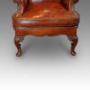 Pair of Queen Anne style walnut wing-chairs front legs