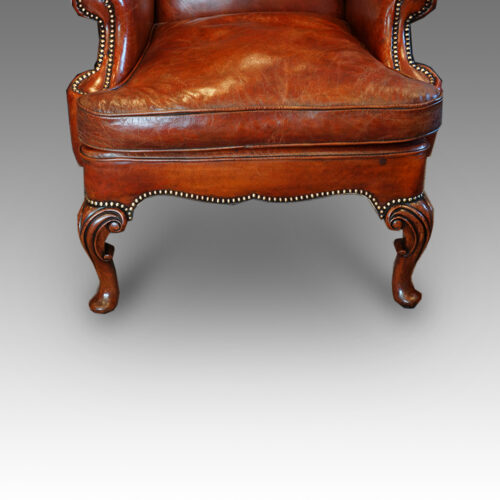 Pair of Queen Anne style walnut wing-chairs front legs