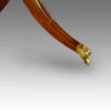 Mahogany triple pillar dining table in the Georgian style, brass paw foot