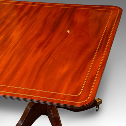 Regency style twin pillar mahogany dining table with line inlay end