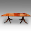 Regency style twin pillar mahogany dining table with line inlay side