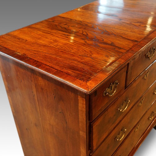 Queen Anne walnut and oak chest top detail