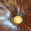 Victorian camphorwood and leather ottoman brass military button