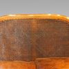 Edwardian walnut bergere sofa cane back
