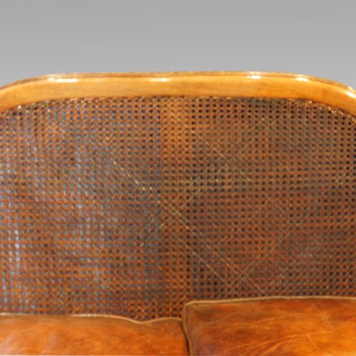 Edwardian walnut bergere sofa cane back