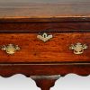 George III oak cross banded dresser base central drawer