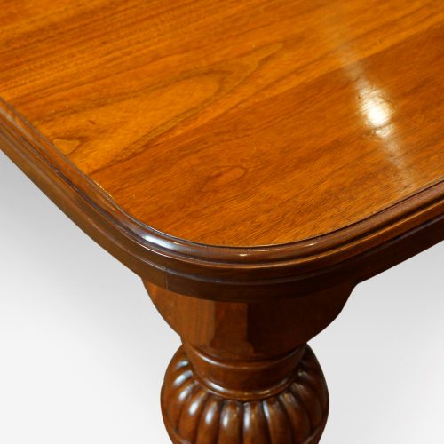 Edwardian walnut extending dining table end from side
