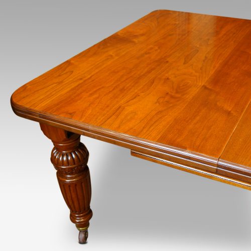 Edwardian walnut extending dining table end from side