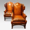 Pair of oak and leather wing chairs