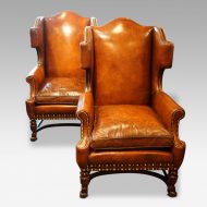 Pair of oak and leather wing chairs