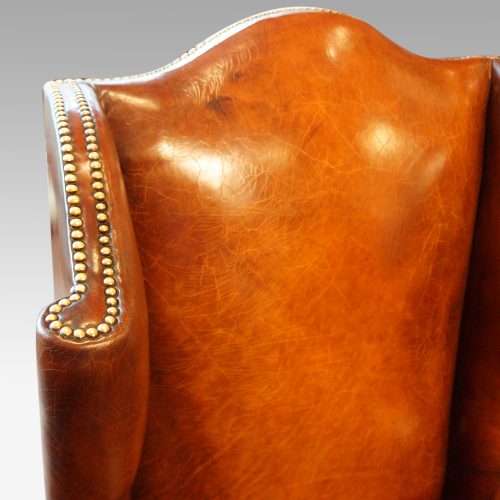 Pair of oak and leather wing chairs back scroll