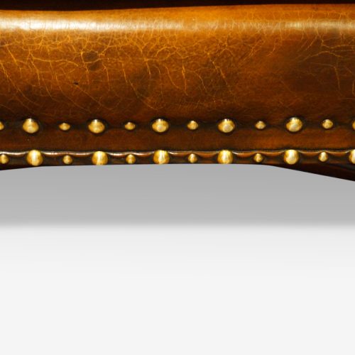Pair of oak and leather wing chairs double studding