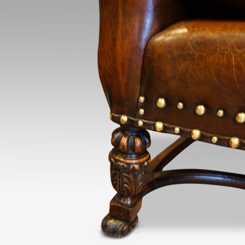 Pair of oak and leather wing chairs front leg