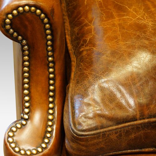 Pair of oak and leather wing chairs front of arm