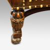 Pair of oak and leather wing chairs leg carving