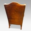Pair of oak and leather wing chairs rear