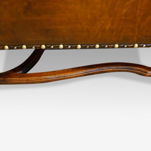 Pair of oak and leather wing chairs side stretcher