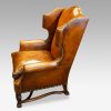 Pair of oak and leather wing chairs side view