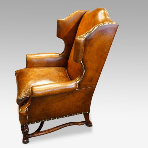 Pair of oak and leather wing chairs side view