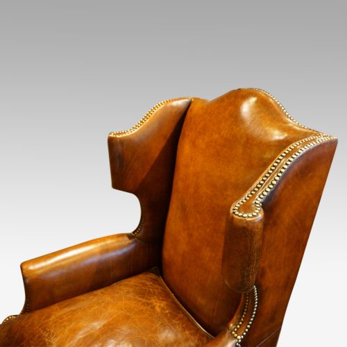 Pair of oak and leather wing chairs wing