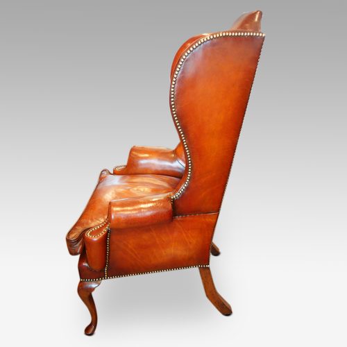 Queen Anne style high back leather wing chair side view