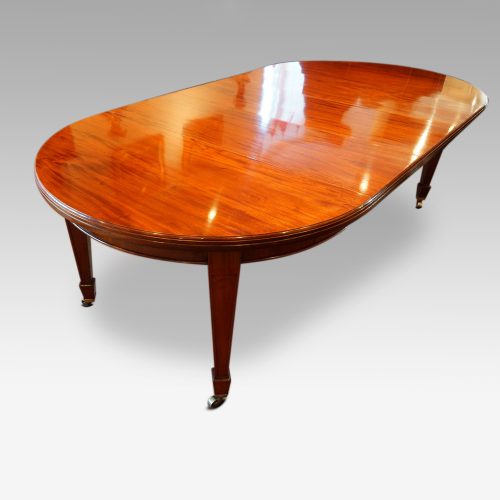Edwardian circular mahogany dining table from corner