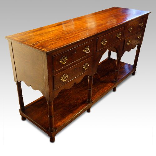 Antique oak potboard dresser base at angle