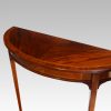 Pair Edwardian mahgany demi lune tables angle view