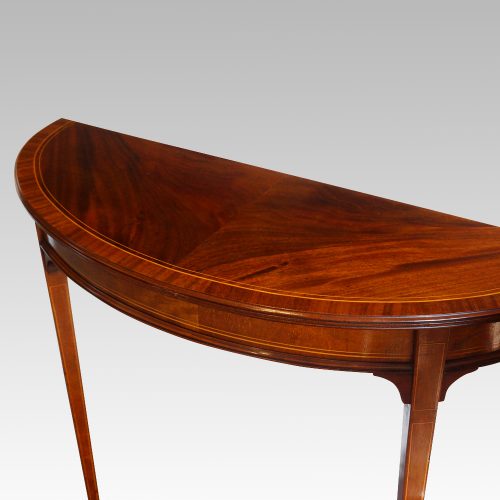Pair Edwardian mahgany demi lune tables angle view