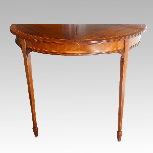 Pair Edwardian mahgany demi lune tables front