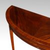 Pair Edwardian mahgany demi lune tables top