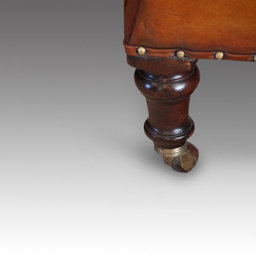 Pair of Victorian leather club chairs front leg