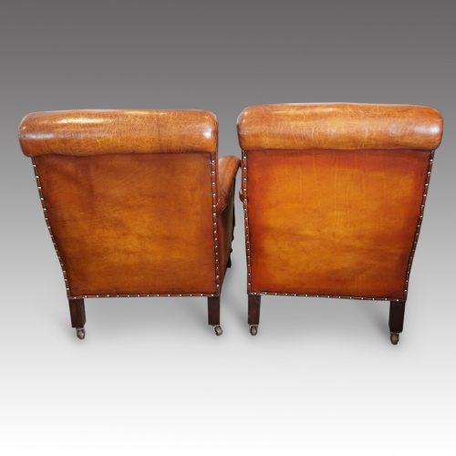 Pair of Victorian leather club chairs rear