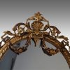 Antique gilt oval mirror crest detail