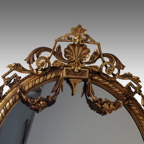 Antique gilt oval mirror crest detail