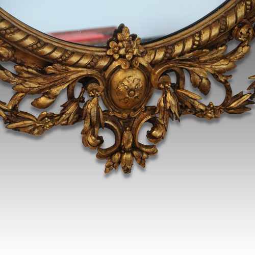 Antique gilt oval mirror detail