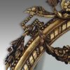 Antique gilt oval mirror shoulder