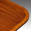 Regency style mahogany twin pillar dining table banding detail