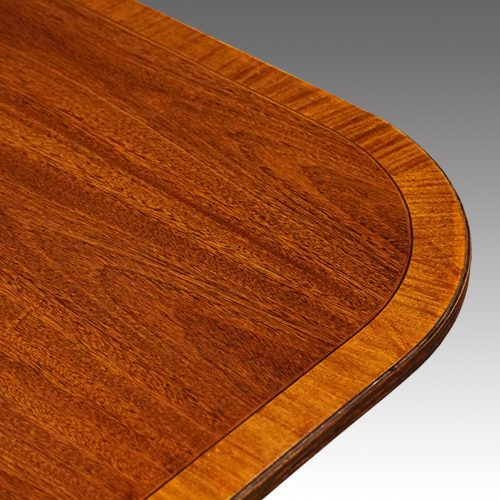 Regency style mahogany twin pillar dining table banding detail